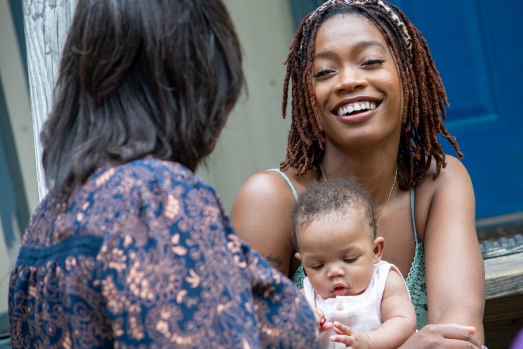 Woman laughing with a community health worker