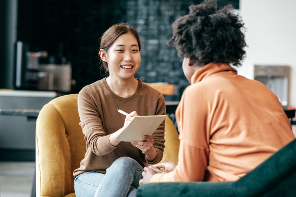 Woman interviewing another woman for research