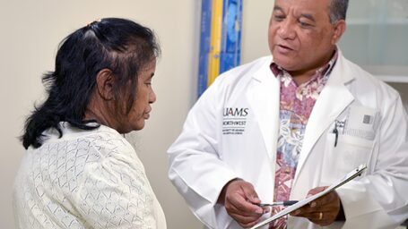 male doctor talking to woman