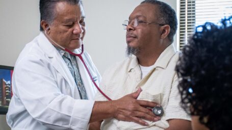 Doctor checking a patient's heartbeat